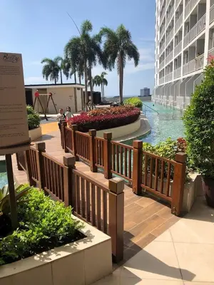 a view of a pool at a resort at Jovic's Condo at Breeze Residences. in Manila