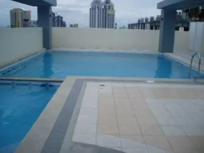 a swimming pool on the roof of a building at Leons Den is a long term accomodation of atleast 1 month stay in Manila