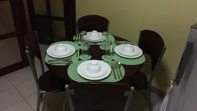 a dining table with green plates and dishes on it at Leons Den is a long term accomodation of atleast 1 month stay in Manila