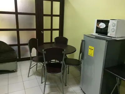 a room with a table and chairs and a microwave at Leons Den is a long term accomodation of atleast 1 month stay in Manila