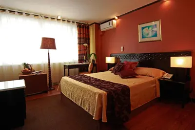 a hotel room with a bed and a window at Manila Manor Hotel in Manila