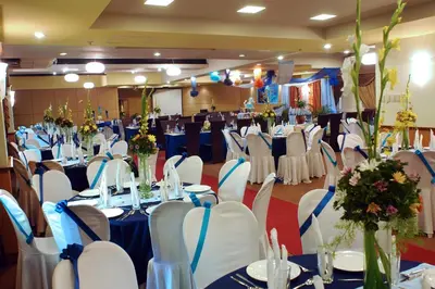 a banquet hall with white tables and chairs at Manila Manor Hotel in Manila