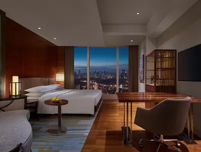 a hotel room with a bed and a view of a city at Grand Hyatt Manila in Manila