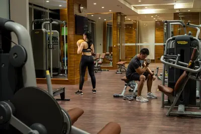 a woman standing in a gym with a man at Grand Hyatt Manila in Manila