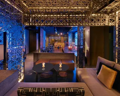 a restaurant with tables and chairs and a bar at Grand Hyatt Manila in Manila