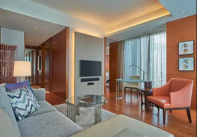 a living room with a couch and a tv and a table at Grand Hyatt Manila in Manila