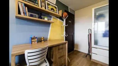 a home office with a wooden desk and a chair at Grand Apartment near BGC in Manila