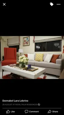 a living room with a couch and a table at Grand Apartment near BGC in Manila
