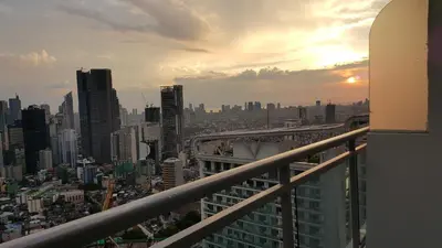 a view of a city from the balcony of a building at Modern Luxury Lower Penthouse Unit in Manila