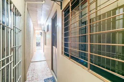 an empty hallway of a building with windows at Conrado's Apartelle in Manila