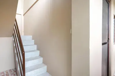 a staircase in a house with white walls at Conrado's Apartelle in Manila