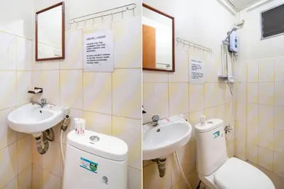 a bathroom with a toilet and a sink at Conrado's Apartelle in Manila