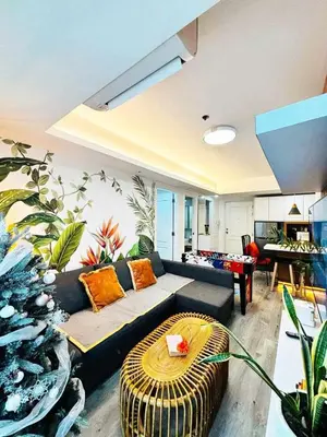 a living room with a couch and a table at Holiday Escape Philippines in Manila