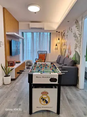 a room with a table with a chess board on it at Holiday Escape Philippines in Manila