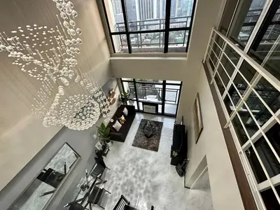 an overhead view of a living room with a chandelier at 2-story Penthouse with 5 Balconies in Manila