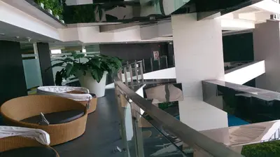 a lobby with chairs and a staircase in a building at 2-story Penthouse with 5 Balconies in Manila