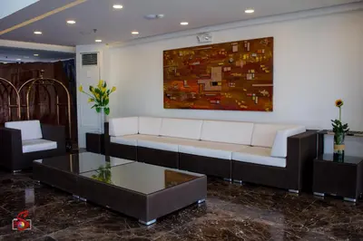 a living room with a couch and a painting on the wall at Hotel Marciano in Calamba