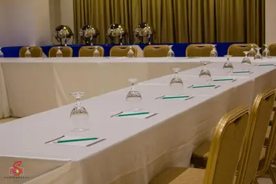 a long table with wine glasses and napkins on it at Hotel Marciano in Calamba