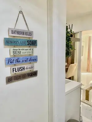 a sign on the wall of a bathroom with a wall at AZURE URBAN RESIDENCES- Beach View in Manila