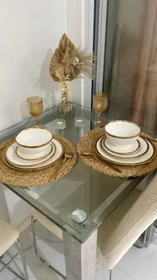 a glass table with plates on top of it at AZURE URBAN RESIDENCES- Beach View in Manila