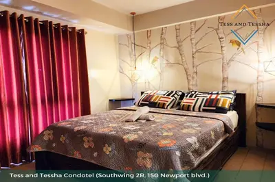 a bedroom with a bed with a teddy bear on it at Tess and Tessha Condotel near T3 Airport in Manila