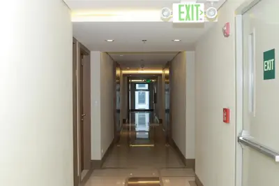 a corridor in a building with a hallway at De Luxe 7QRS in Manila
