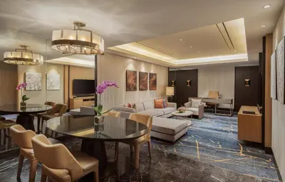 a lobby of a hotel with tables and chairs at Hilton Manila Newport World Resorts in Manila