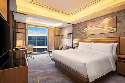 a hotel room with a bed and a desk at Hilton Manila Newport World Resorts in Manila