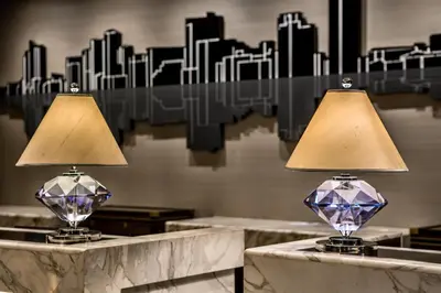 two lamps on a marble table in front of a city at Diamond Hotel Philippines in Manila