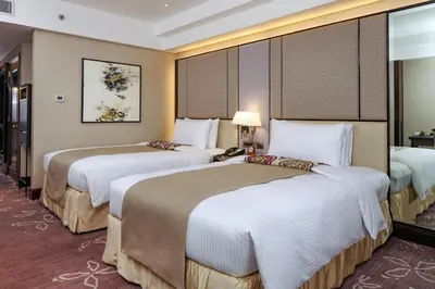 a hotel room with two beds in it at Diamond Hotel Philippines in Manila