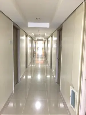 an empty corridor in a building with a hallway at Sea Breeze Studio Manila in Manila