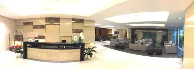a large lobby with couches and a reception desk at Sea Breeze Studio Manila in Manila