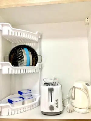 a toaster and other kitchen items in a refrigerator at Sea Breeze Studio Manila in Manila