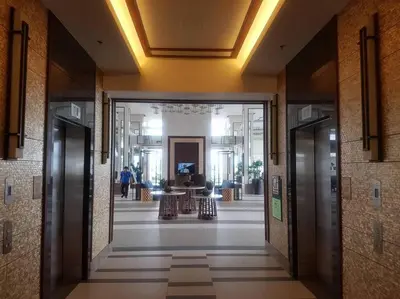 a hallway of a building with two elevators in it at Modern Urban Living - Resort Amenities in Manila