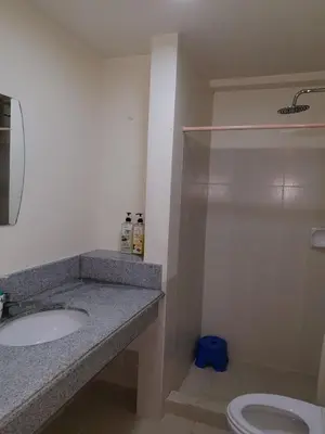 a bathroom with a sink and a shower and a toilet at Modern Urban Living - Resort Amenities in Manila