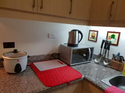 a kitchen with a counter top with a microwave at Modern Urban Living - Resort Amenities in Manila