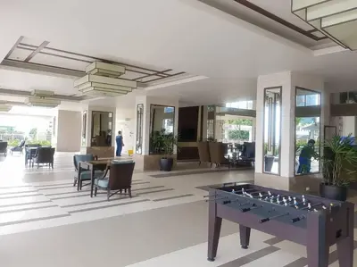 a large living room with a table and chairs at Modern Urban Living - Resort Amenities in Manila