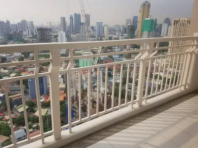 a balcony with a view of a city at Modern Urban Living - Resort Amenities in Manila