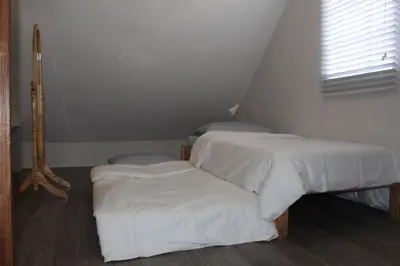 two beds with white sheets in a room at # 15 Laguna Bel-Air Home in Sta Rosa by Red Door House Rental in Santa Rosa