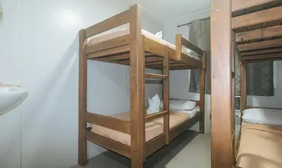 two bunk beds in a room with a sink at Metro Deluxe Residences near World Trade Center in Manila