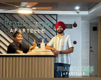 a man standing in front of a counter with a woman at Frank Lloyd Apartelle in Manila