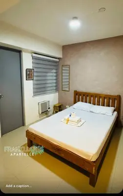 a bedroom with a large bed with white sheets at Frank Lloyd Apartelle in Manila