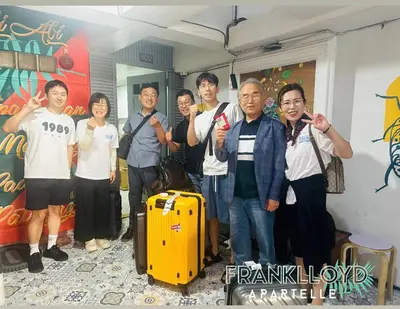 a group of people posing for a picture at Frank Lloyd Apartelle in Manila