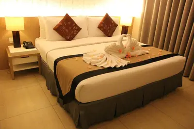 a hotel room with a bed with two swans on it at Mount Sea Resort in Rosario