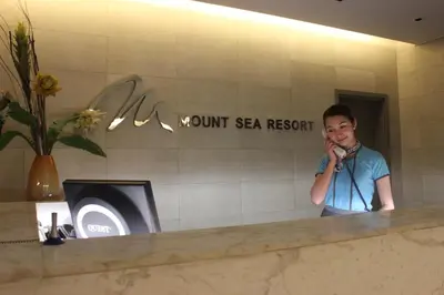 a young boy talking on a cell phone in a bathroom at Mount Sea Resort in Rosario