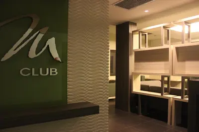 a hotel room with a club sign on the wall at Mount Sea Resort in Rosario