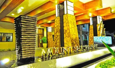 a lobby of a building with a sign that reads miami at Mount Sea Resort in Rosario