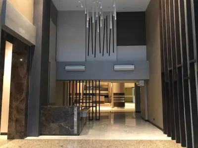 a hallway with a chandelier in a building at Portovita Towers in Manila
