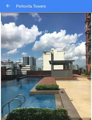 a swimming pool on the roof of a building at Portovita Towers in Manila