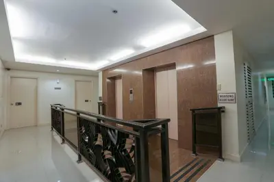 a hallway with a staircase in a building at Paragon Tower Hotel in Manila